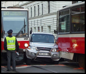 Car squashed between two trams