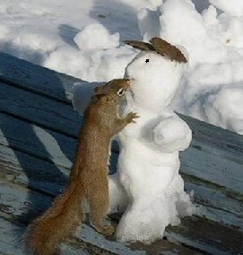 Snowman kissed by squirrel