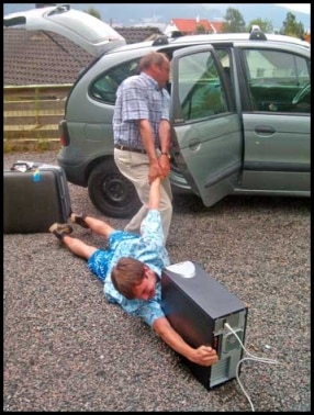 dad dragging son into car