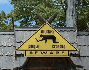 drunk crossing roof sign