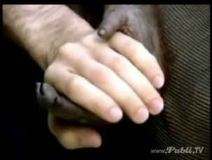 Who is holding his hand?