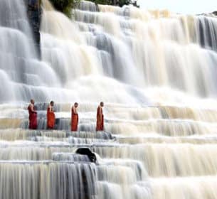 Buddhist Monks in Waterfall